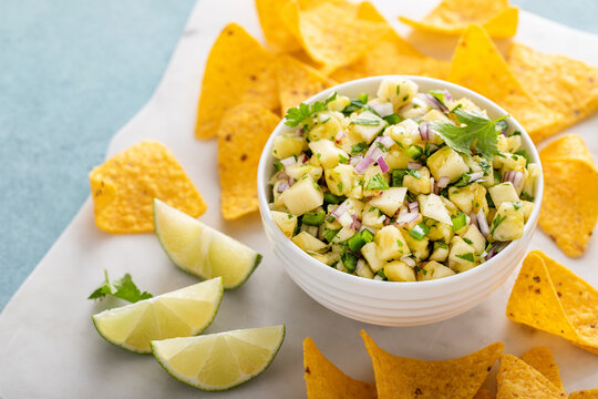 Fresh pineapple and jalapeno salsa in a bowl with tortilla chips