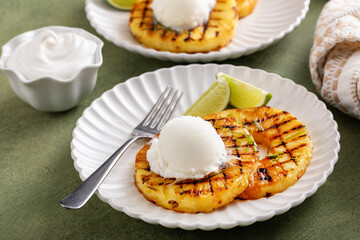 Grilled pineapple with lime honey glaze and whipped cream