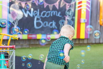 Fototapeta premium Preschool child playing in a vibrant fun outdoor kindergarten yard