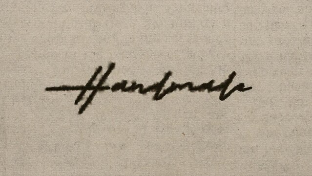 Script font graphic with ink bleeding into paper and on green screen, writing the text "handmade", in 4k at 60fps.