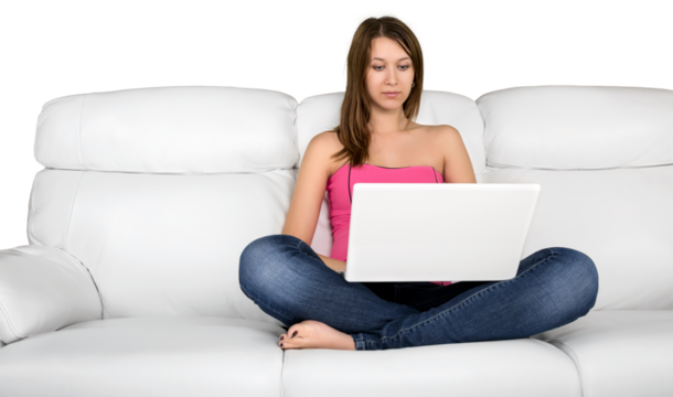 Portrait of a Young Woman Using her Laptop While Sitting on a Couch