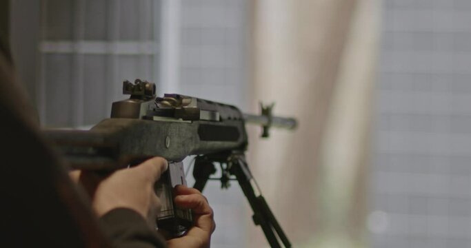 Shooter loading a magazine in Ruger Mini-14 rifle in slow motion