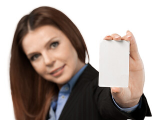 Young woman holding blank card and looking at camera