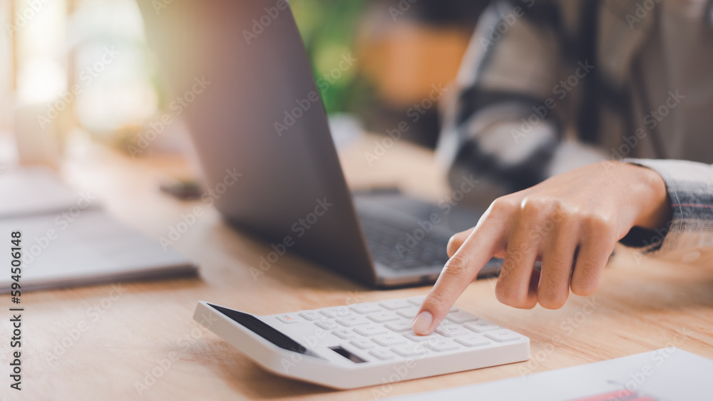 Fototapete businessman using a calculator to calculate numbers ,profit and loss statement review of company per