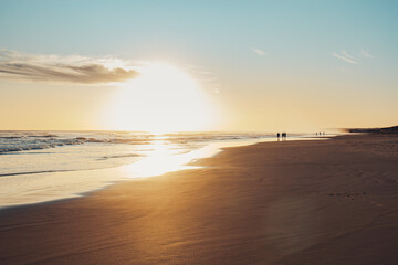 Long exposure of bright orange sunset over the tropical sea and sky with clouds. Beautiful sunset blue summer.