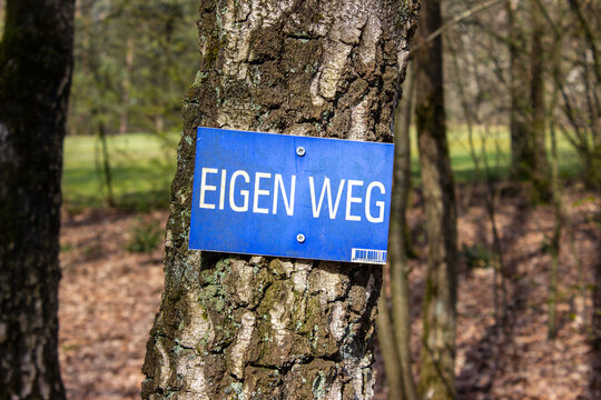 Own way, Eigen Weg Sign in Netherlands hanging in the forest