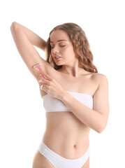 Fototapeta premium Young woman shaving her armpit with razor on white background