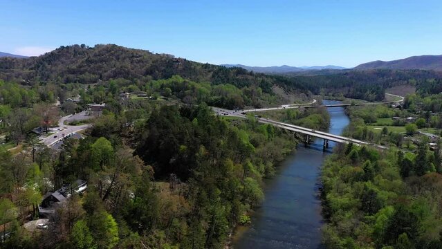 Freeway over a river in Murphy, NC. Forest and mountains landscape. Aerial shot.