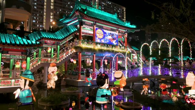 Nighttime view of a public park decorated with Chinese lanterns at a lantern show as visitors are seen inside the Wong Tai Sin temple complex during the Mid-Autumn Festival (Mooncake Festival).