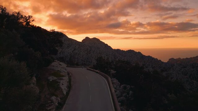 Sa Calobra mountain road sunset, Palma de Mallorca. Serpentine street, Hairpin Bend and clouds. Scenic Majorca Island nature aerial drone footage. Famous for racing bikes bicycles. Cinematic 4K UHD
