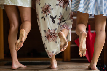 The bride and bridesmaids have dirty feet. Walking without shoes. Bare feet. Funny photo