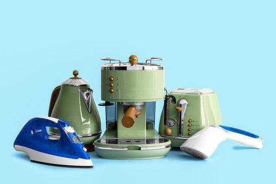 Set of modern household appliances on blue background
