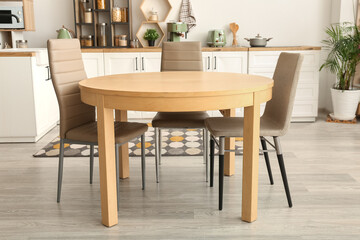 Clean dining table and chairs in interior of kitchen