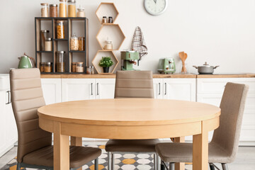 Clean dining table and chairs in interior of kitchen