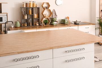 Table with drawers in interior of modern kitchen