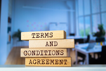 Wooden blocks with words 'Terms and Conditions Agreement'. Business concept