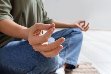 Beautiful woman meditating in bedroom, closeup