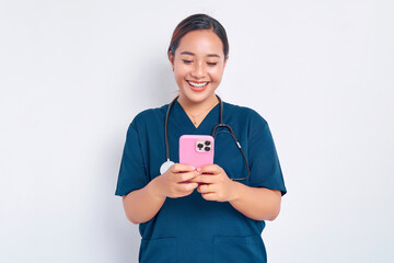 Smiling friendly young Asian woman nurse working wearing a blue uniform using a mobile phone on...
