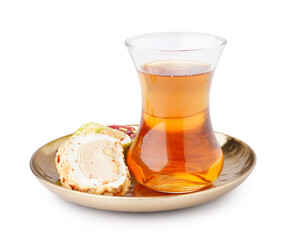 Plate with tasty Turkish Delight and glass of tea isolated on white background