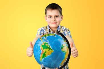 Cheerful student child with globe. School concept.