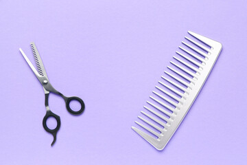 Hair comb with scissors on violet background