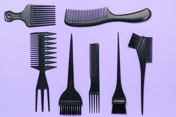 Hairdresser's brushes on violet background