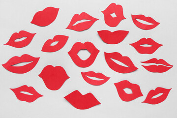 Red paper lips on light background