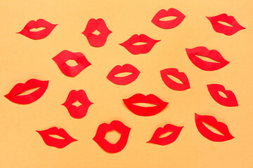 Red paper lips on color background