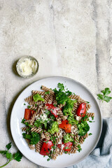 whole grain pasta fusilli with grilled bell pepper and broccoli. Top view with copy space.
