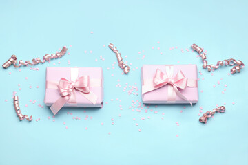 Gift boxes with beautiful bows, serpentine and confetti on blue background