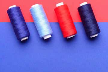 Different sewing threads on color background