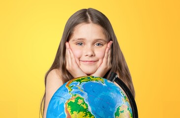 Cheerful student child with globe. School concept.