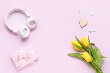 Composition with modern headphones, gift box, decor and tulip flowers on color background