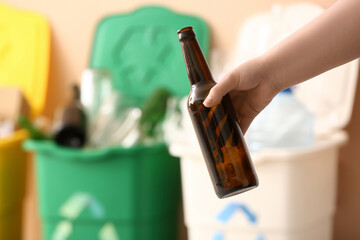 Woman throwing garbage into trash bin, closeup. Recycling concept