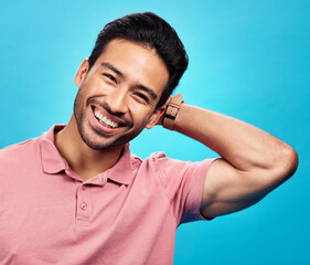 Smile, happy and portrait of Asian man on blue background with pride, confidence and happiness....