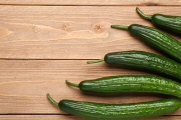 Fresh cucumbers on wooden background, closeup