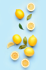 Composition with fresh lemons on blue background