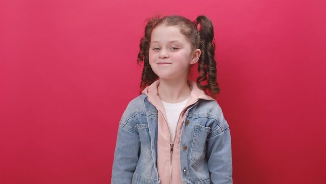 Portrait of preeten girl kid looking surprised at camera with big eyes, shocked by sudden victory, game winning lottery goal achievement good news, posing on red background. Oh my God, Wow concept