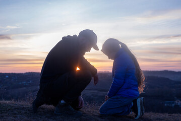 Father and daughter are kneeling and praying. Family prayer. Kneeling Repentance for sins. father's...