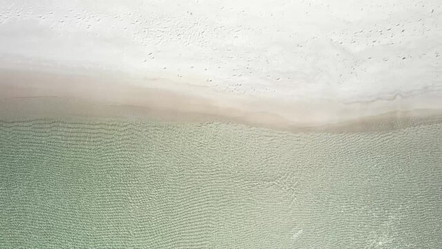Rippling Water In The Shoreline Of Empty Beach In Summer. - aerial overhead