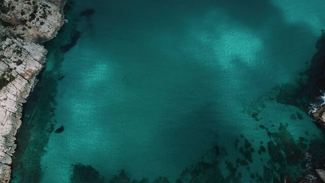 Palma de Mallorca Island, natural Cala Clara, Sant Vicenc, near Cap Formentor. Turquoise blue clear sea seaside perfect beach coast. Spanish Balearic Majorca cinematic idyllic aerial drone 4K UHD.