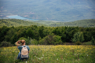 Fototapeta na wymiar woman with backpack on a hill green forest hike nature journey