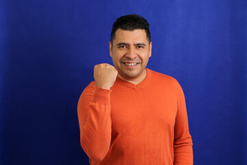 Latin adult man shows herself happy, blissful, lucky, satisfied, full, carefree, dances and shows...