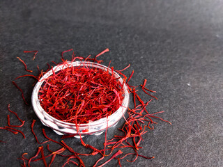 the closeup picture of red saffron kept on a black background