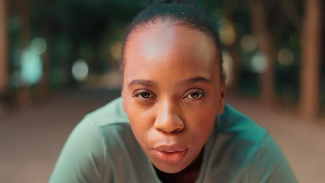 Face closeup, tired black woman and fitness with breathing rest on a nature trail on run. Runner, workout and female with exercise fatigue of a sprinter on a path for cardio and wellness training