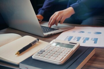 Business accounting women work with calculator and Laptop. Financial technology concept