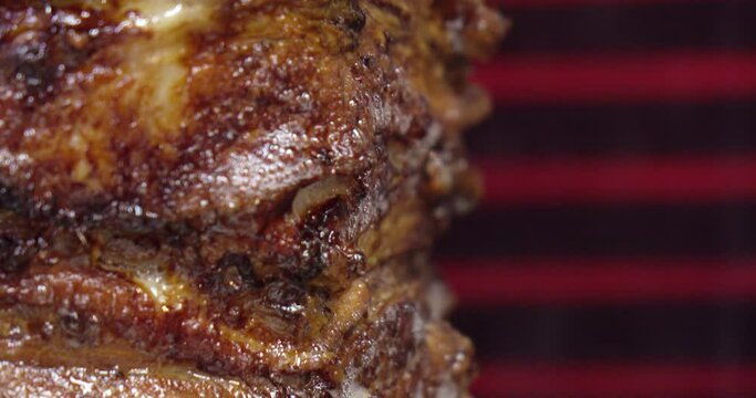 Meat on a spit . Cooking doner kebab or shawarma on a rotating vertical spit. Traditional street fast food
