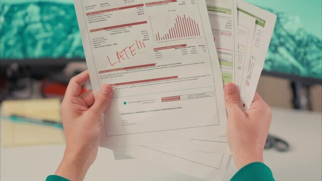 Male Latino Hands Look Through Overdue Water, Power and Gas Bills. Shot with ARRI Alexa in ARRIRAW at 23.98 fps and exported QuickTime Apple ProRes 422 HQ.