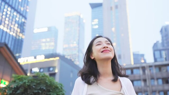 Beautiful girl walking on the road, smiling happily and confident