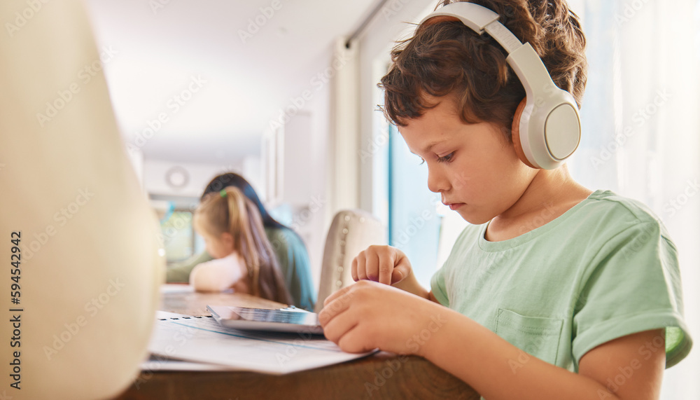 Sticker Child, headphones and tablet for education and learning at a home table with internet connection. Boy kid using technology for educational mobile app, streaming video and movies or listening to sound